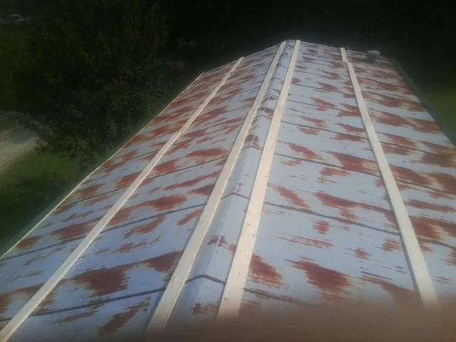 Rusted metal roof panels with new wood purlins before replacement — Storm Damage Roof Repair in Arapahoe by Roofing Brothers